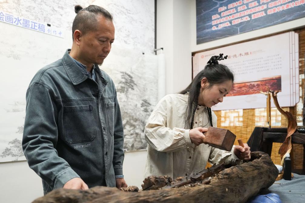 潘能輝和妻子胡美華在湖南常德河街展示木雕。新華社記者 薛宇舸 攝